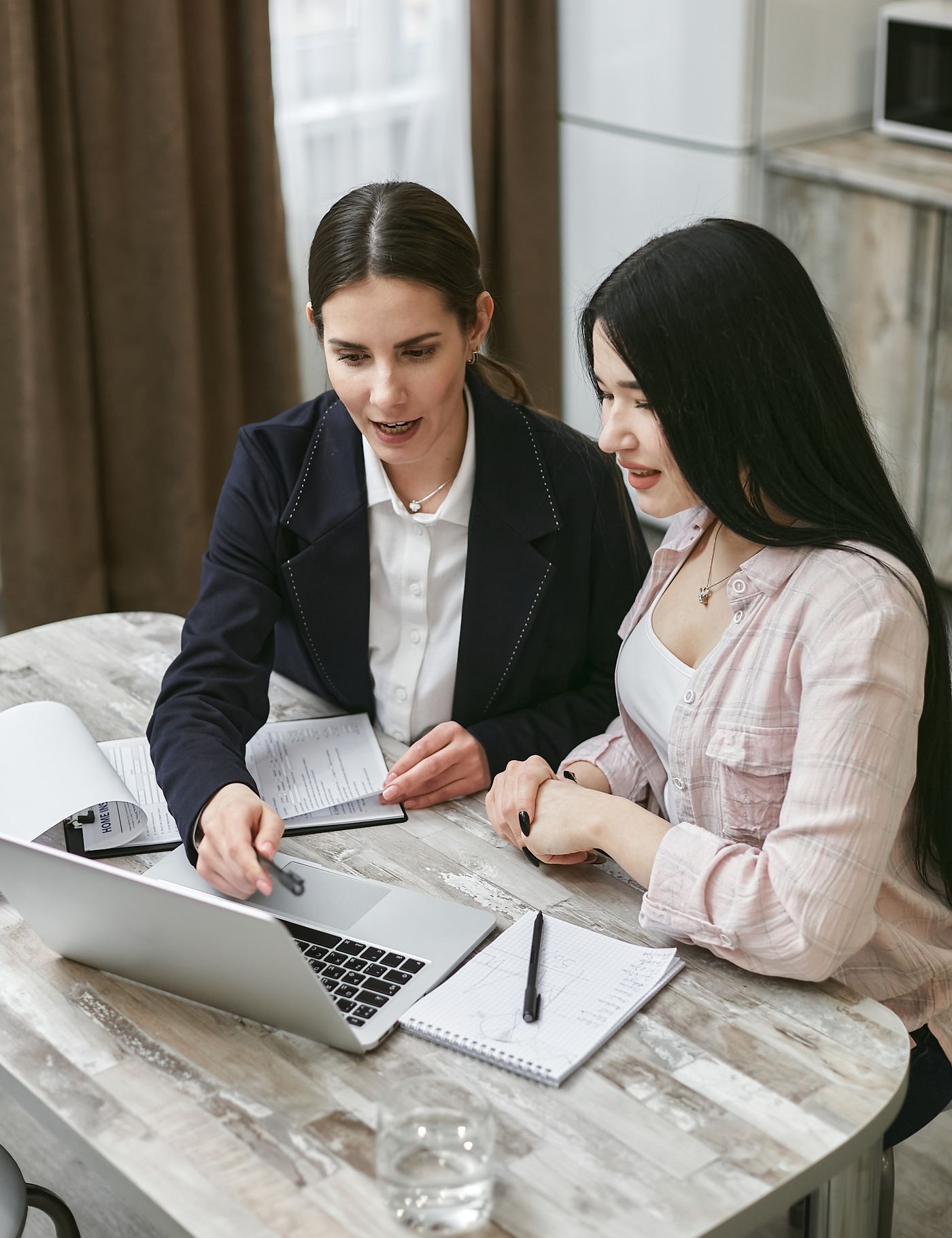 A business owner and an AltaGrade specialist looking at a laptop together